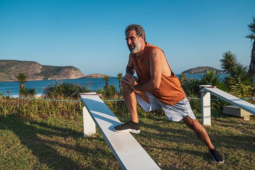Portrait of an active senior in sportswear, preparing for outdoor exercise