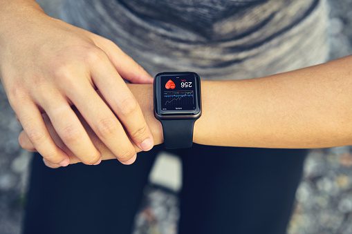young-woman-checking-the-sports-watch-measuring-heart-rate-and-after-picture-id1157775252