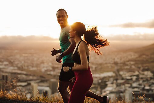 couple-running-at-sunrise-picture-id1286012253