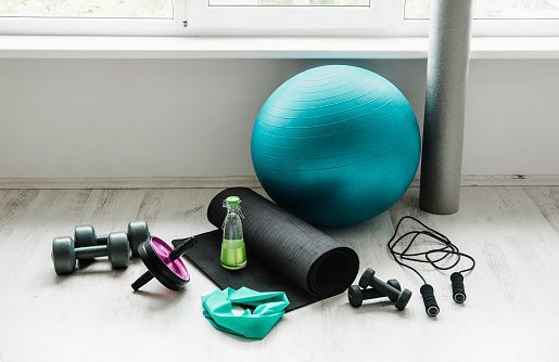 group-of-different-exercising-equipment-on-white-home-gym-floor-ball-picture-id1274950193