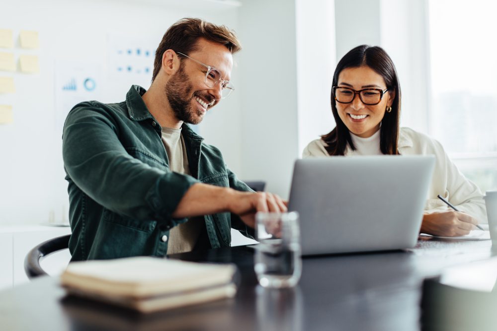 two-business-people-using-laptop